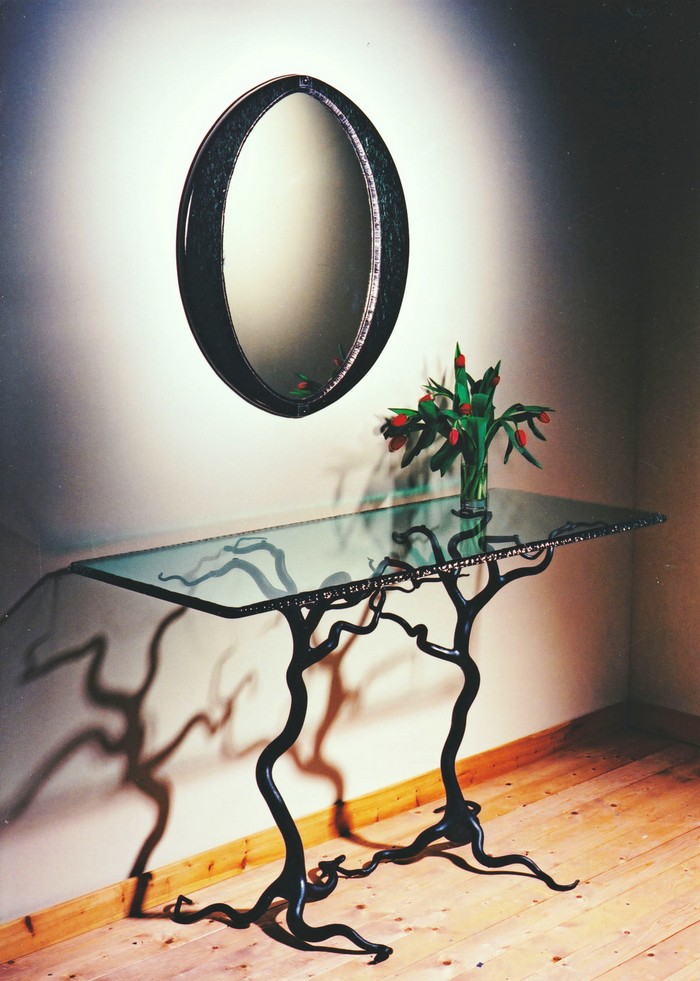 "One of the items taht will be at aution is the "Savernake forest" a forged steelcenter table by Mark Reed."
