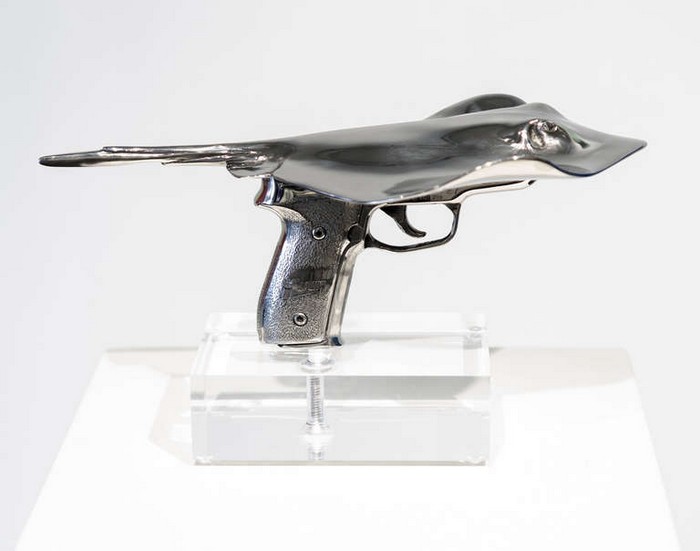 Christopher Schulz is an artist that has come up with these 3D metal sculptures, fusing sharks and rays with guns.